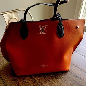 Louis Vuitton brown with black handles leather bag, never used